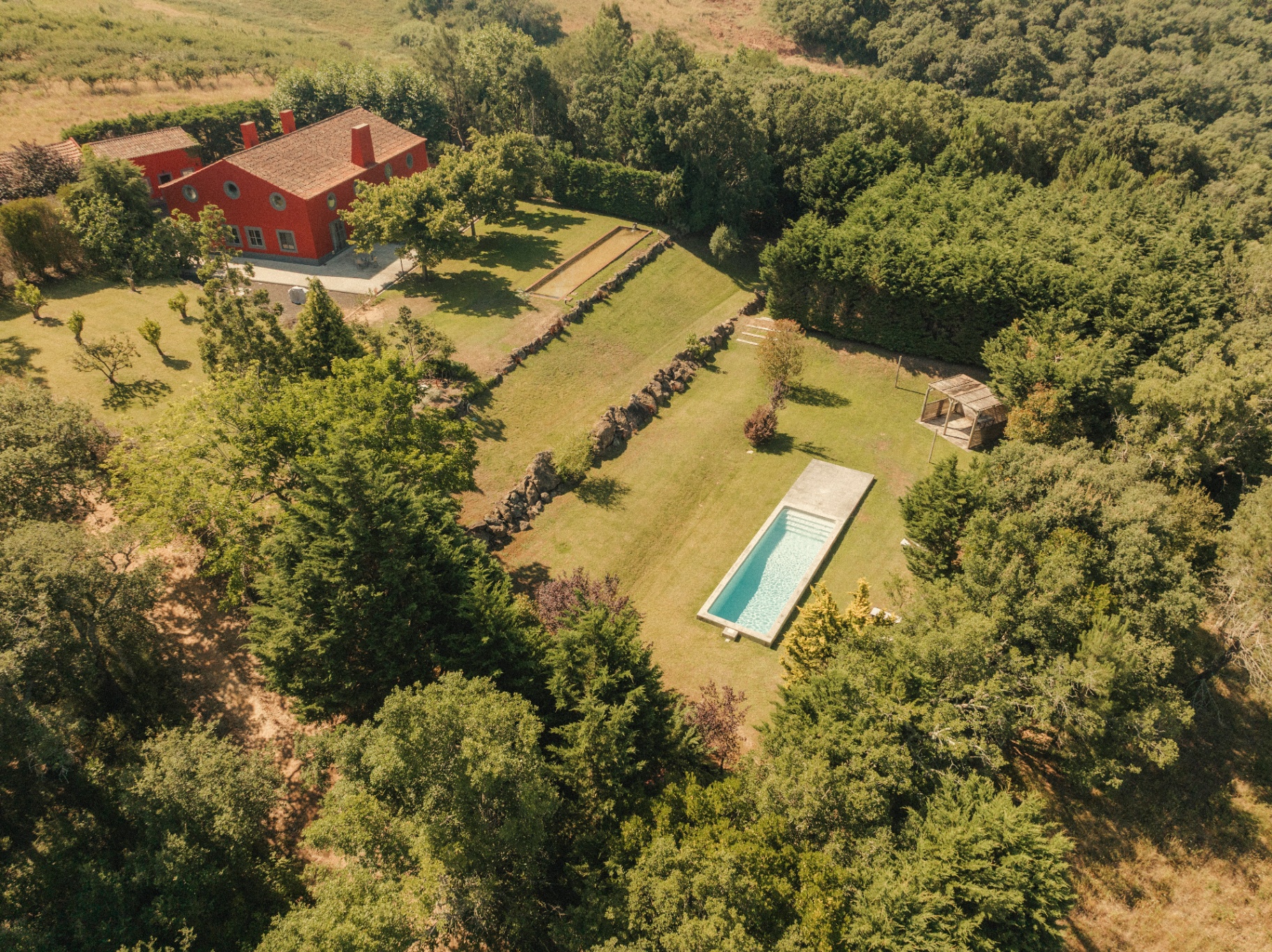 Aerial view of the house, gardens and pool from another angle